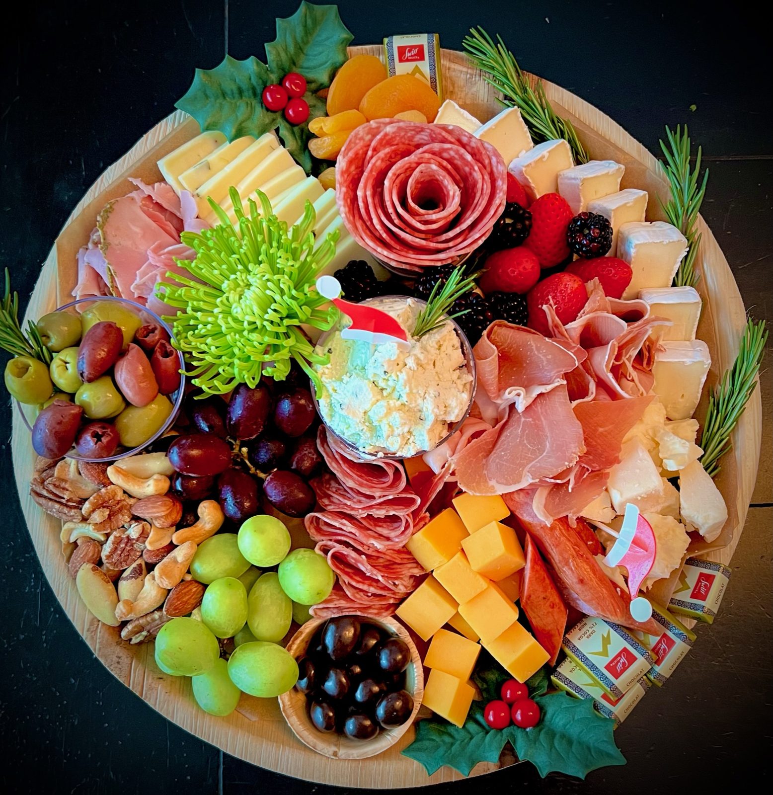 Floral-styled board with prosciutto, melon, olives, and nuts