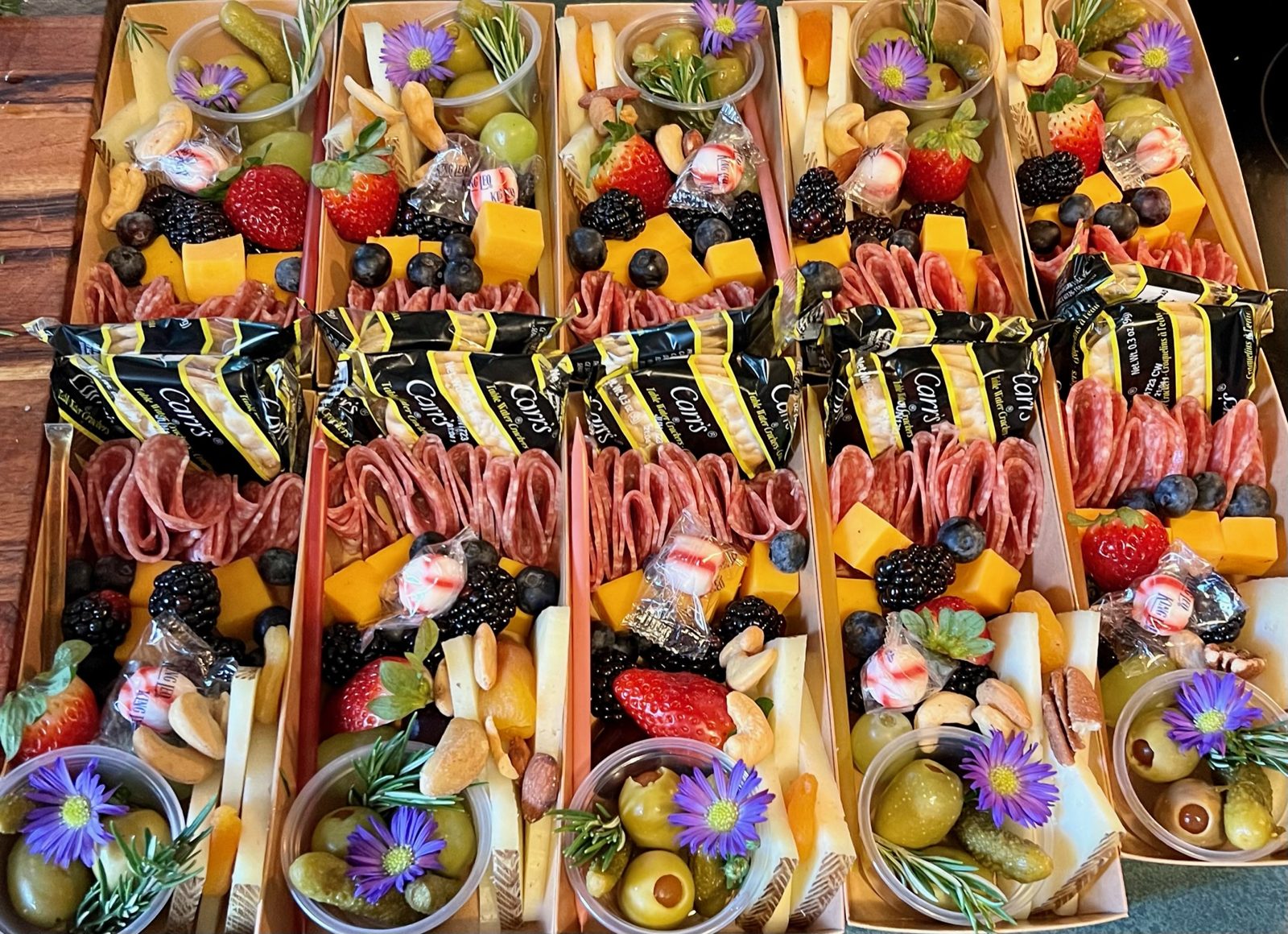 Individual charcuterie boxes lined up for a party
